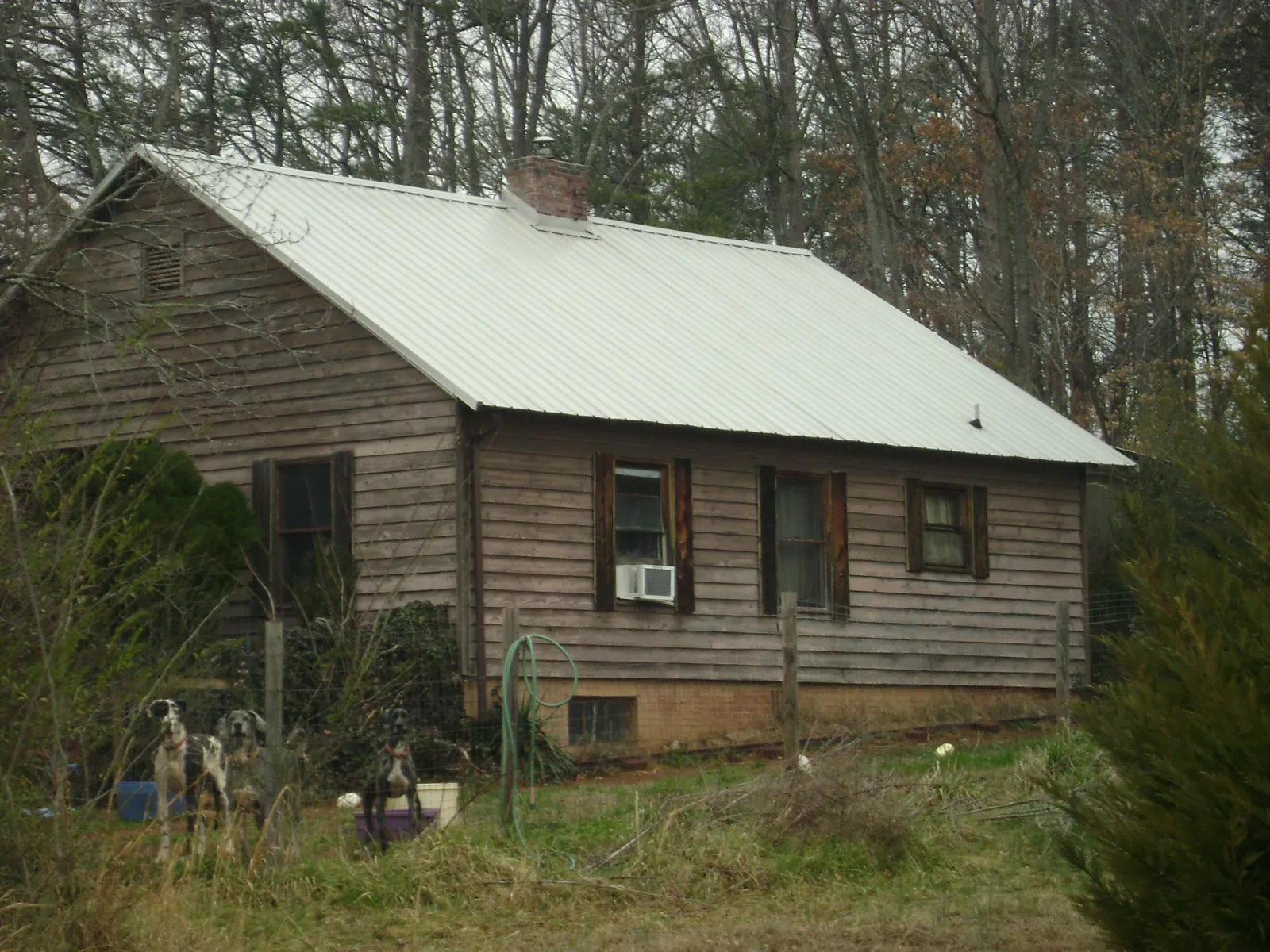 White metal roof on an old wood sided farmhouse, from a Metal Roof Installation job in Lawndale
